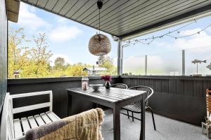 a table and chairs on a balcony with a view at 8528-Grenaa-Klitten-28 in Grenå +19 photos