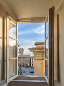 an open window with a view of a city at La finestra sul Teatro in Cortona