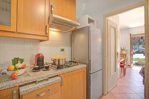 a kitchen with a stove and a refrigerator at Bardonest - Central Studio in Bardonecchia - Happy Rentals in Bardonecchia