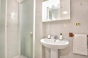 a white bathroom with a sink and a shower at Bardonest - Central Studio in Bardonecchia - Happy Rentals in Bardonecchia