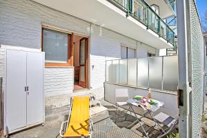 a patio with a table and chairs on a balcony at Bardonest - Central Studio in Bardonecchia - Happy Rentals in Bardonecchia