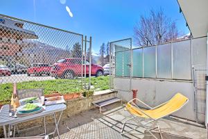 a patio with a table and chairs and a fence at Bardonest - Central Studio in Bardonecchia - Happy Rentals in Bardonecchia +11 photos