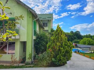a house with two trees in front of it at Ram house1 in Piteşti