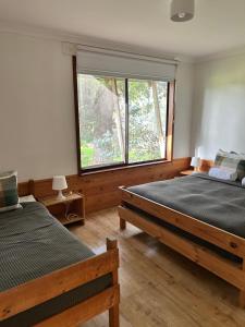 a bedroom with two beds and a large window at Turicum AT Monkey Rock Winery & Cider in Parryville