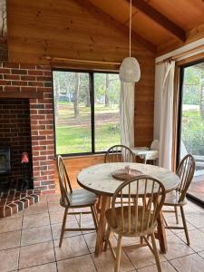 a dining room with a table and chairs and a fireplace at Turicum AT Monkey Rock Winery & Cider in Parryville