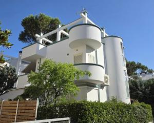 a white house with a cross on the side of it at Villa Dyrrahu with Pool & Sea Access in Golem