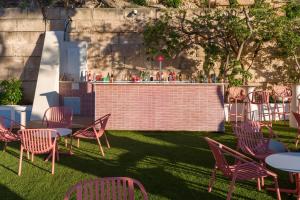 a group of tables and chairs and a bar at Hotel Vibra Beverly Playa in Paguera +107 photos