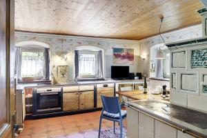 a kitchen with a table and a chair in it at Ferienhaus Stadlerhof in Rettenschöss