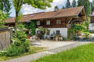 a large wooden house with a yard at Ferienhaus Stadlerhof in Rettenschöss
