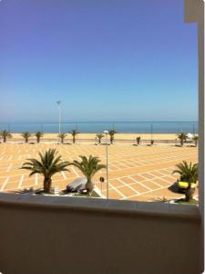 a view of a beach with palm trees and the ocean at Appartamenti Bramante in Vieste +72 photos