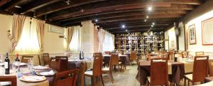 a dining room with tables and chairs and a library at Apartamentos Turísticos los Abuelos in Montemayor de Pililla