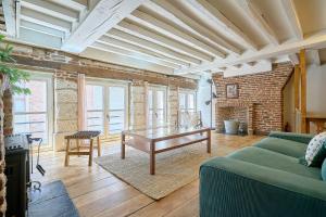 a living room with a green couch and a table at Old Town - Lovely typical house in Lille