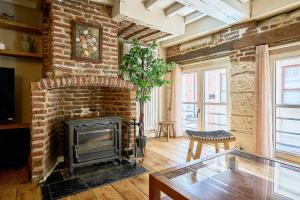 a living room with a brick fireplace and a table at Old Town - Lovely typical house in Lille