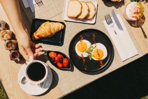 a table with eggs and bread and a cup of coffee at Pillow urban stay in Thessaloniki