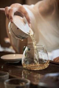 a person pouring liquid into a glass bowl at HUALUXE Beijing Xinan in Beijing +93 photos