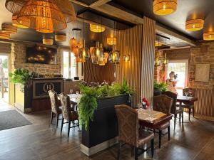 a restaurant with a table and chairs and lights at Chambres côté mer du bouquet in Cosqueville