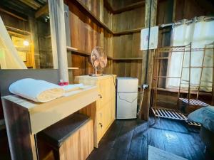 a room with a desk with a fan and a refrigerator at ปางสูงเฮาส์ pangsunghouse in Ban Pang Bo Hu Bon +199 photos