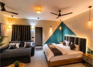 a bedroom with a bed and a couch at The Boho Peach Villa in Mount Ābu