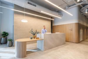 a man standing behind a counter in an office at Quest Southport in Gold Coast