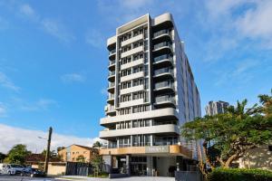 a tall building with a sign that reads quest at Quest Southport in Gold Coast