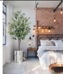 a bedroom with a brick wall and a bed at Honeydon in Eaton Socon
