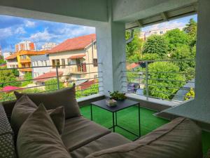 a living room with a couch and a view of a city at Ramhouse in Piteşti