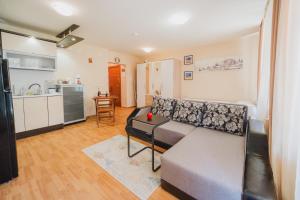 a living room with a couch and a kitchen at Iglika Beach in Golden Sands