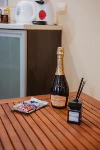 a bottle of wine sitting on top of a wooden table at Iglika Beach in Golden Sands