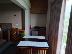 a kitchen with a table and a counter top at Windowind Resort in Koroth