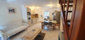 a living room with a couch and a table at CASA FOCI - maison T3 in Zonza