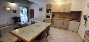 a kitchen and living room with a table in it at CASA FOCI - maison T3 in Zonza