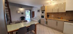 a kitchen with a table and chairs in a room at CASA FOCI - maison T3 in Zonza +9 photos