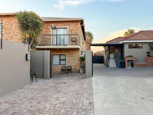 a brick house with a patio in front of it at Cosmo Sleepover in Roodepoort
