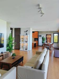 a living room with a couch and a table at The LakeFront Villa in Binangonan