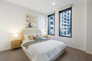 a white bedroom with a bed and two windows at The Rush in Campbell +18 photos