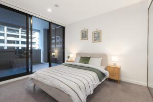 a bedroom with a bed and a large window at The Rush in Campbell