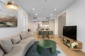 a living room with a couch and a table at The Rush in Campbell
