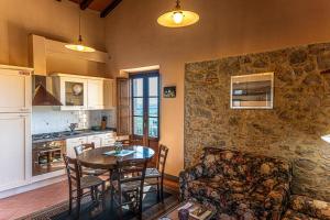 a kitchen with a table and chairs and a couch at Agriturismo Morisfarms - Santa Laura in Cura Nuova