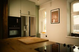 a kitchen with a cutting board on a table at Pokrzepka in Spychowo +71 photos