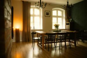 a kitchen with a table and chairs and a dining room at Pokrzepka in Spychowo