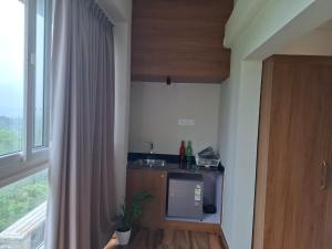 a small kitchen with a sink and a window at Windowind Resort in Koroth +12 photos