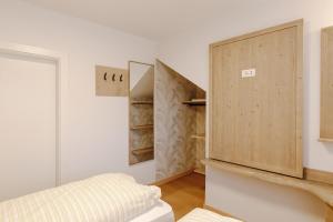 a room with a closet with a wooden door at Appartamento Borésc - area wellness in Arabba