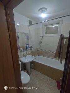 a bathroom with a sink and a tub and a toilet at Khongor Guest house & Tours in Ulaanbaatar +77 photos
