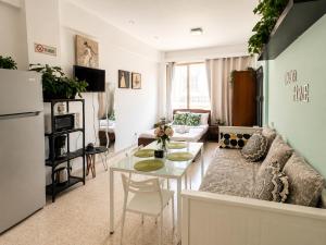 a living room with a couch and a table at Oasis - Cosy Studio in Larnaca in Larnaca