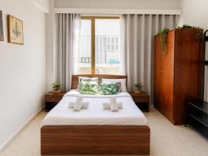 a bedroom with a large bed and a window at Oasis - Cosy Studio in Larnaca in Larnaca