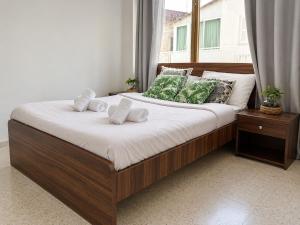 a bed with two pillows on it in a bedroom at Oasis - Cosy Studio in Larnaca in Larnaca +8 photos