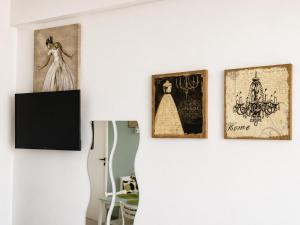 a room with three framed pictures on a wall at Oasis - Cosy Studio in Larnaca in Larnaca
