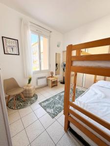 a bedroom with a bunk bed and a large window at Résidence les 4 Horizons in Cerbère