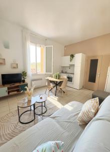a living room with a couch and a table at Résidence les 4 Horizons in Cerbère