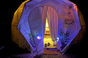 a purple tent with lights inside of it at Pewsey Countryside Dome - Dog Friendly - Fire pit in Pewsey